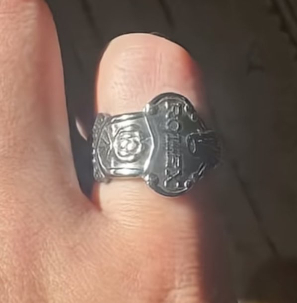 Ornate signet-style ring on finger